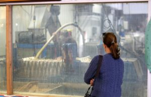 A customer watches cider being made.